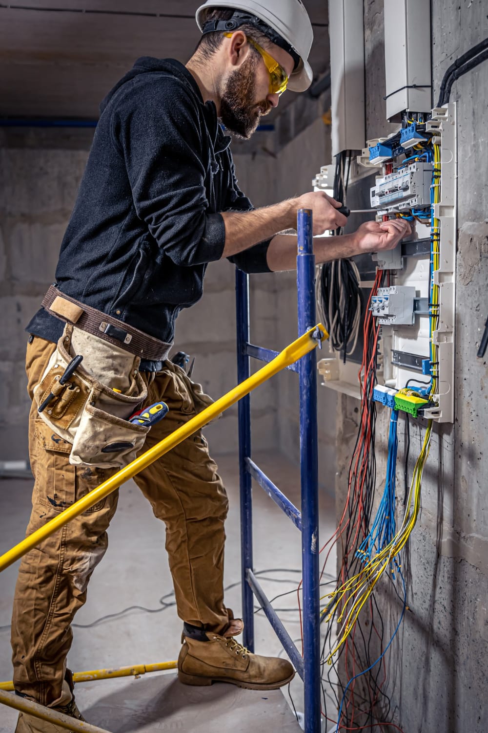 a man working on a electrical panel