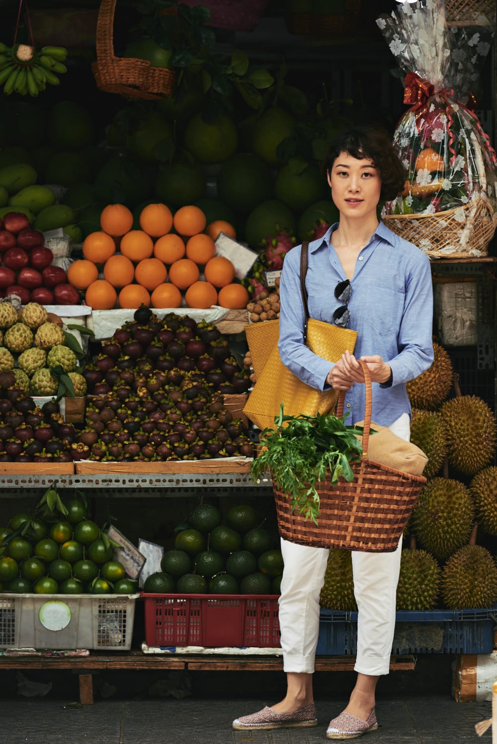 a woman holding a basket of vegetables